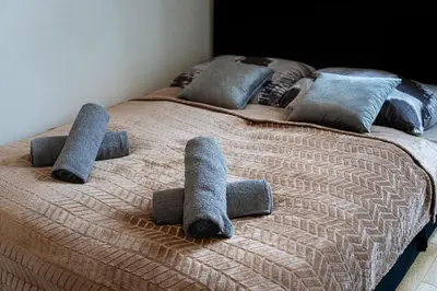 a bed with three pillows on top of it at Golden Aurora Prague in Prague