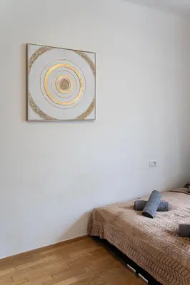 a bed in a room with a picture on the wall at Golden Aurora Prague in Prague