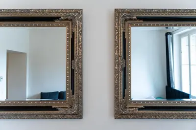 two mirrors on a wall in a room at Golden Aurora Prague in Prague