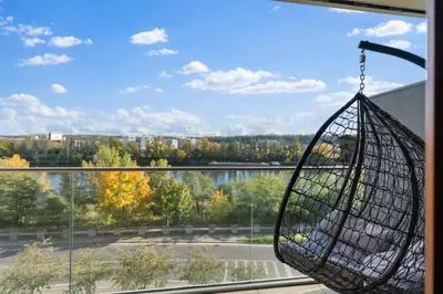 a bird cage hanging from a window with a view at Sunset Terrace Residence in Prague