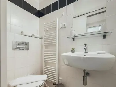 a white bathroom with a sink and a toilet at Magical Prague Old Town in Prague