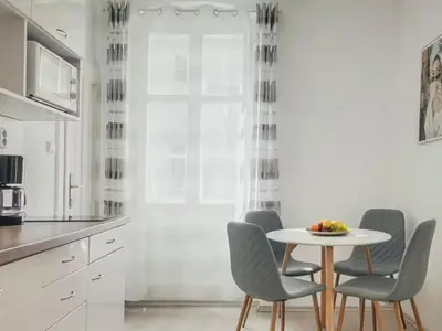 a kitchen with a table and chairs in a kitchen at Magical Prague Old Town in Prague