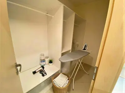 a small bathroom with a sink and a stool at Fortuna Garden V in Prague