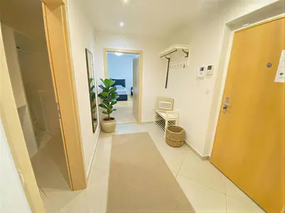 a hallway of a hospital with a door and a plant at Fortuna Garden V in Prague