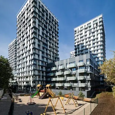 two tall buildings with a playground in front of them at Fortuna Garden V in Prague