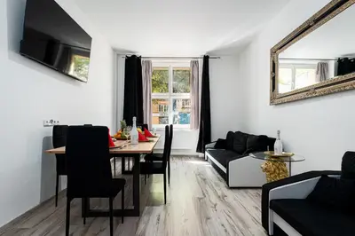 a living room with a table and a couch at Lion Prestige Residence in Prague