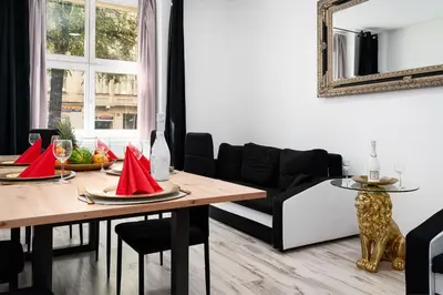 a living room with a table and a couch at Lion Prestige Residence in Prague