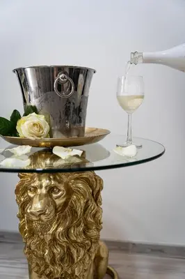a glass table with a bowl and a wine glass at Lion Prestige Residence in Prague