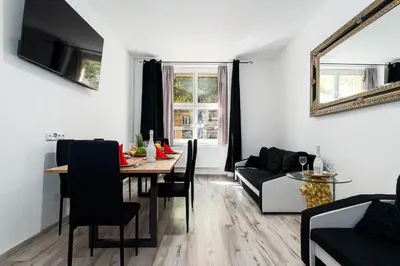 a living room with a table and a couch at Lion Prestige Residence in Prague