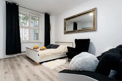 a bedroom with a bed and a mirror on the wall at Lion Prestige Residence in Prague