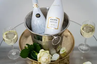 a bucket of wine and two glasses of wine at Lion Prestige Residence in Prague