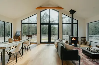 a living room with a fireplace and a table and chairs at Grand Gallery Riverside in Prague