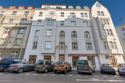 a building with cars parked in front of it at Grand Gallery Riverside in Prague