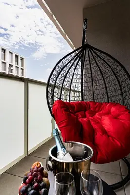 a balcony with a red couch and a bowl of fruit at Bohemian Luxe Central in Prague