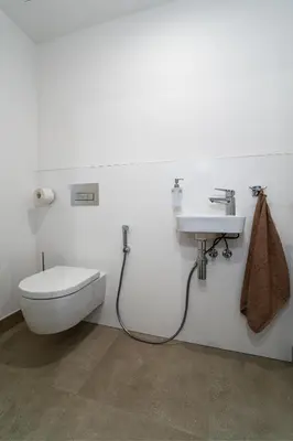 a bathroom with a toilet and a sink at Big Central Living in Prague