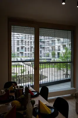 a dining room table with a view of a large window at Big Central Living in Prague