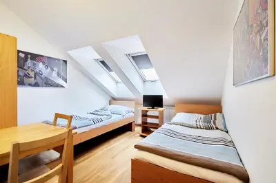 two beds in a room with skylights at Apartmány Ubytování Alfa in Prague