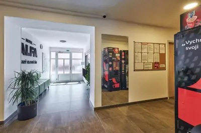 an entrance to a store with a potted plant in a hallway at Apartmány Ubytování Alfa in Prague