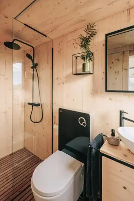 a bathroom with a toilet and a sink at TINY HOUSE na Řehenickém Dvorku in Řehenice