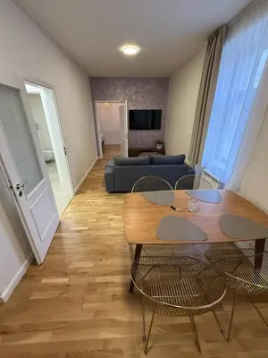 a living room with a table and chairs and a couch at Apartment with garage for 4 people in Prague