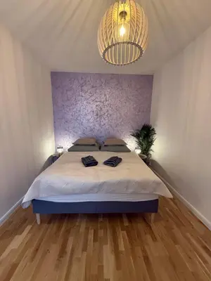 a bedroom with a bed and a chandelier at Apartment with garage for 4 people in Prague