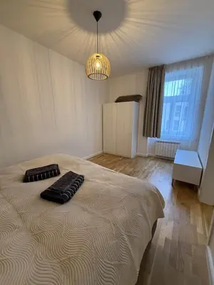 a bedroom with a large bed with a chandelier at Apartment with garage for 4 people in Prague