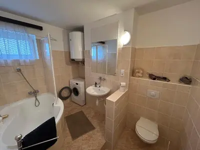 a bathroom with a tub and a toilet and a sink at Prague apartment - Close to airport and metro in Prague