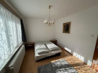 a living room with a bed and a window at Prague apartment - Close to airport and metro in Prague