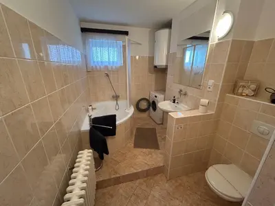 a bathroom with a tub and a toilet and a sink at Prague apartment - Close to airport and metro in Prague