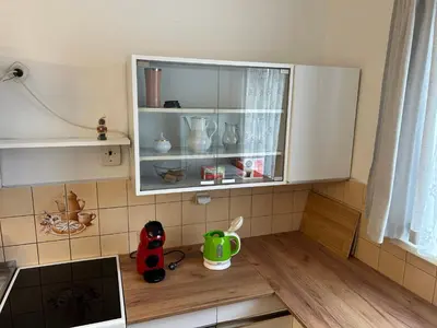 a kitchen counter with a cupboard with dishes on it at Prague apartment - Close to airport and metro in Prague