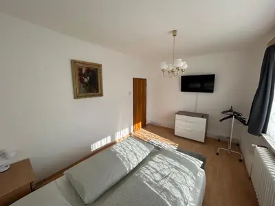 a bedroom with a bed and a flat screen tv at Prague apartment - Close to airport and metro in Prague