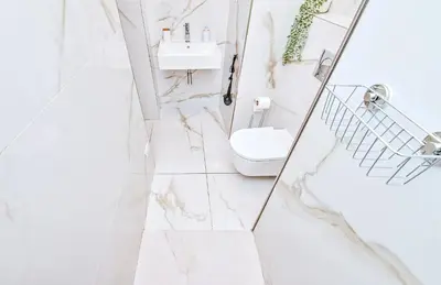 a white bathroom with a sink and a toilet at Kora Premiere Collection in Prague