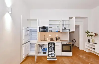 a kitchen with white cabinets and a counter top at Kora Premiere Collection in Prague