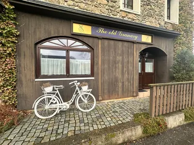 a bike parked in front of a building at Apartmány v Buši in Buš