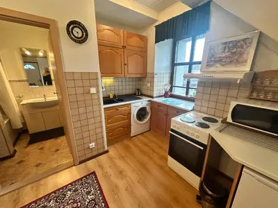 a kitchen with a sink and a stove top oven at Apartmány v Buši in Buš