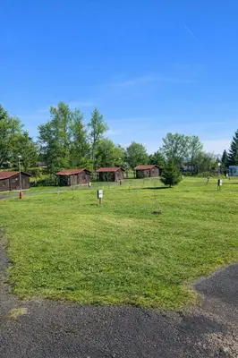 a field with a group of buildings in the distance at Autocamp Kosmonosy in Mladá Boleslav