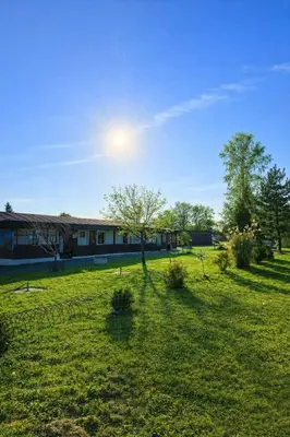 a field of grass with a building in the background at Autocamp Kosmonosy in Mladá Boleslav