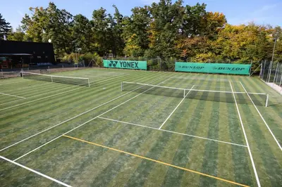 two tennis courts on a grass tennis court at Autocamp Kosmonosy in Mladá Boleslav