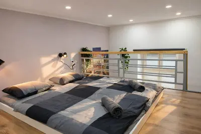 a bedroom with a large bed with pillows on it at Prague Muzeum Apt - 2 min to Wenceslas Sq, Praha 1 in Prague