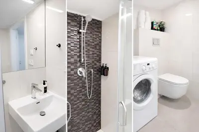 a bathroom with a sink and a washing machine at Prague Muzeum Apt - 2 min to Wenceslas Sq, Praha 1 in Prague
