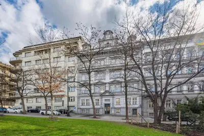 a large white building with trees in front of it at Prague Muzeum Apt - 2 min to Wenceslas Sq, Praha 1 in Prague