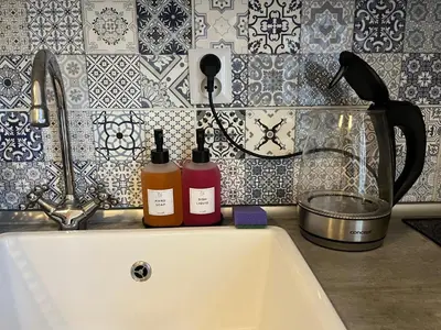 a bedroom with a bed with a comforter and a window at Loft in the heart of Anděl in Prague