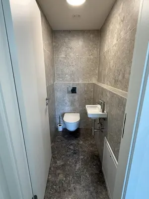 a bathroom with a toilet and a sink at Luxury 3-room apartment with swimming pool - Modřany in Prague