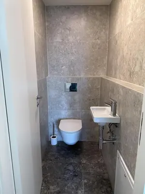 a bathroom with a toilet and a sink at Luxury 3-room apartment with swimming pool - Modřany in Prague