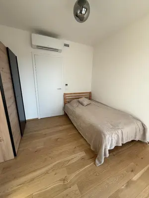 a bedroom with a bed and a wooden floor at Luxury 3-room apartment with swimming pool - Modřany in Prague
