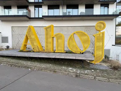 a yellow metal sign that says rave in front of a building at Luxury 3-room apartment with swimming pool - Modřany in Prague