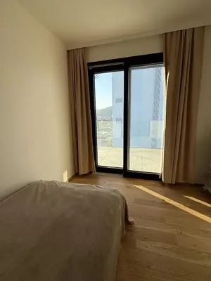 a bedroom with a bed and a large window at Luxury 3-room apartment with swimming pool - Modřany in Prague