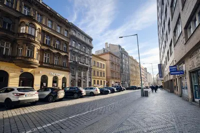 a street with cars parked on the side of the road at Cozy Apartment in the heart of Prague in Prague