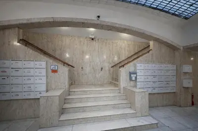 a hallway with stairs and lockers in a building at Cozy Apartment in the heart of Prague in Prague