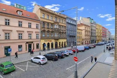 a city street with cars parked on the street at Cozy Apartment in the heart of Prague in Prague